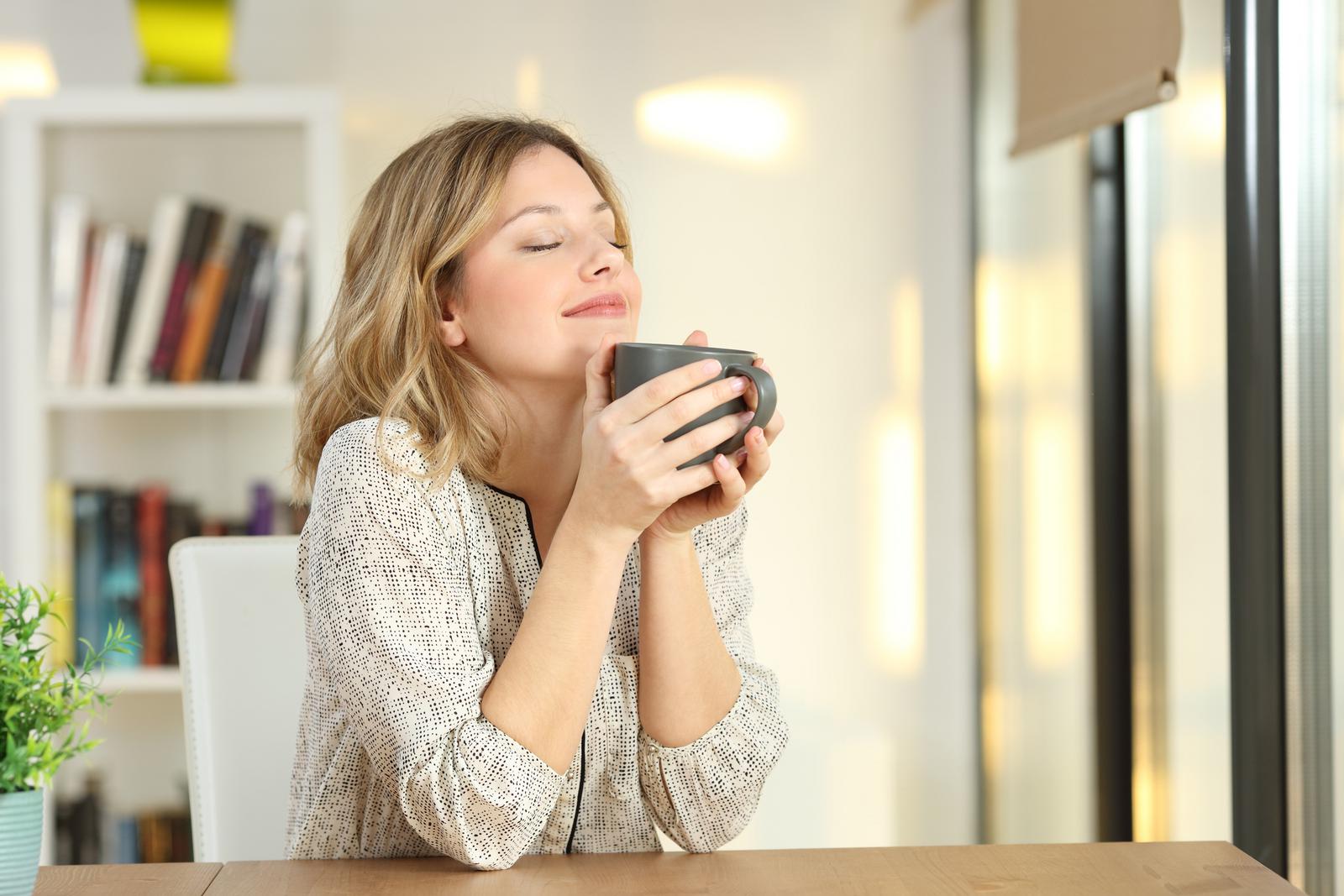 Woman with clear skin drinking coffee
